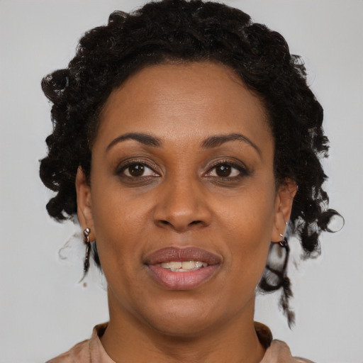 Joyful black adult female with short  brown hair and brown eyes