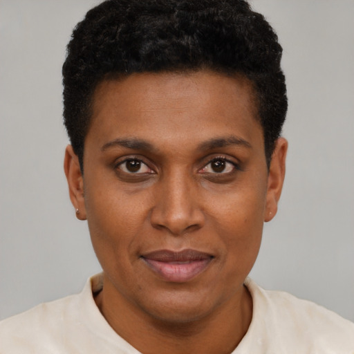 Joyful black young-adult female with short  black hair and brown eyes