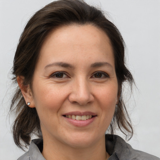 Joyful white adult female with medium  brown hair and brown eyes