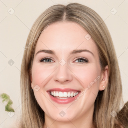 Joyful white young-adult female with long  brown hair and green eyes