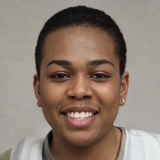 Joyful black young-adult female with short  black hair and brown eyes