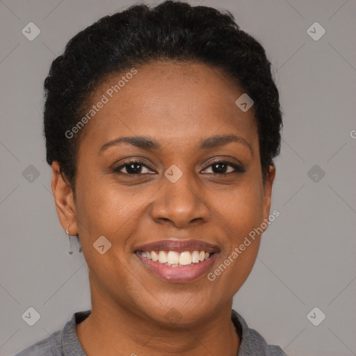 Joyful black young-adult female with short  brown hair and brown eyes