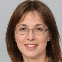 Joyful white adult female with medium  brown hair and grey eyes