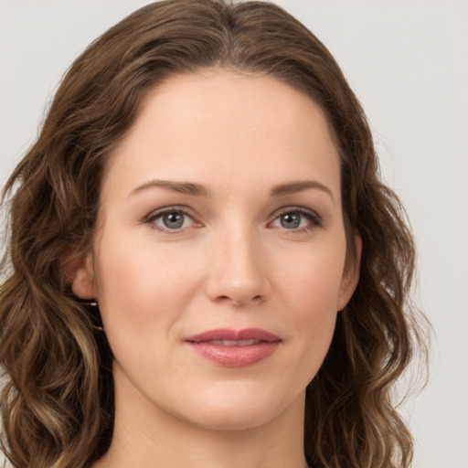 Joyful white young-adult female with long  brown hair and green eyes