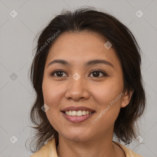 Joyful latino young-adult female with medium  brown hair and brown eyes