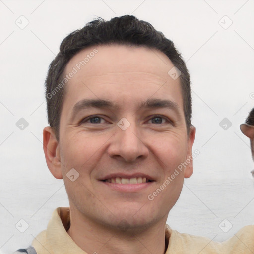 Joyful white young-adult male with short  brown hair and brown eyes