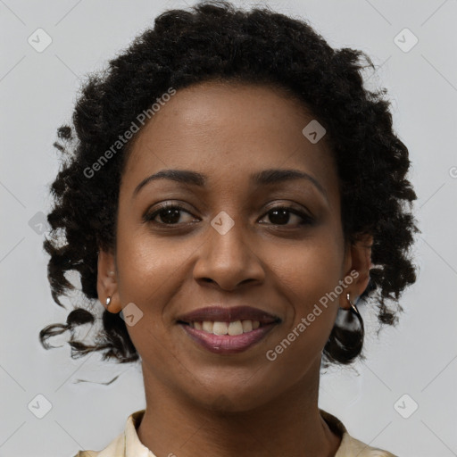 Joyful black young-adult female with short  brown hair and brown eyes