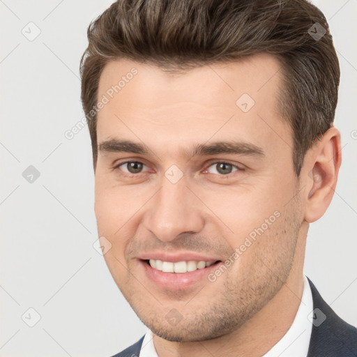 Joyful white young-adult male with short  brown hair and brown eyes