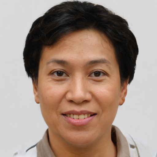 Joyful asian adult female with short  brown hair and brown eyes