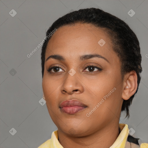 Joyful black young-adult female with short  black hair and brown eyes