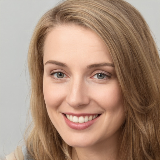 Joyful white young-adult female with long  brown hair and green eyes