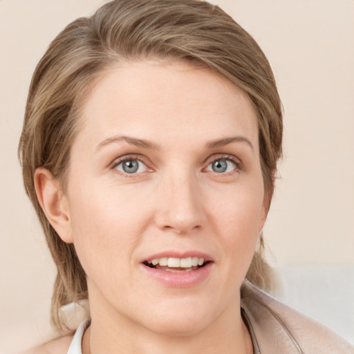 Joyful white young-adult female with medium  brown hair and grey eyes