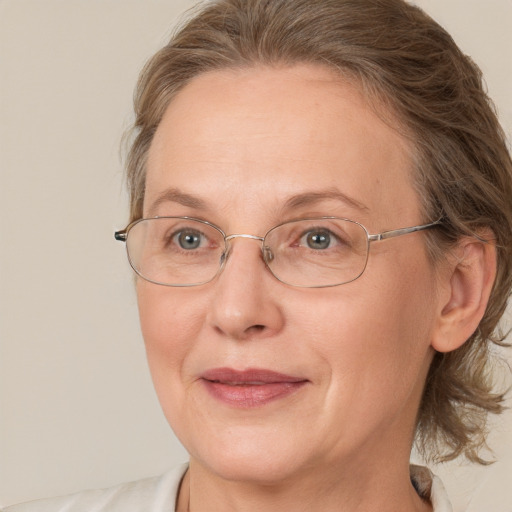 Joyful white middle-aged female with medium  brown hair and blue eyes