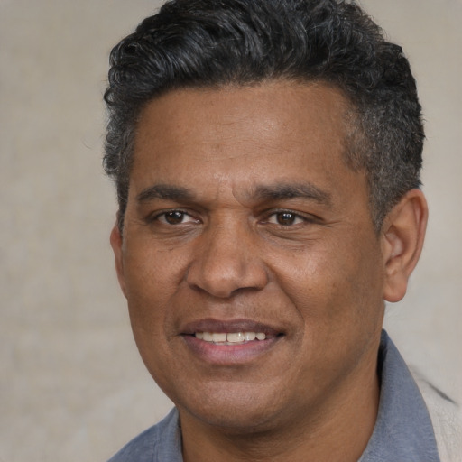Joyful white adult male with short  black hair and brown eyes