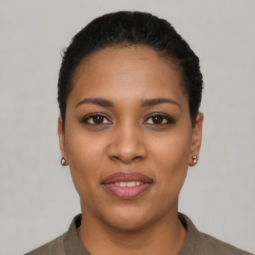 Joyful black young-adult female with short  black hair and brown eyes