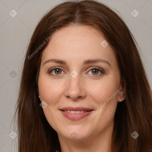 Joyful white adult female with long  brown hair and brown eyes