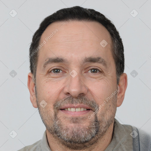 Joyful white adult male with short  black hair and brown eyes