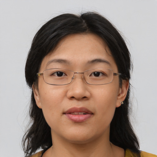 Joyful asian adult female with medium  brown hair and brown eyes