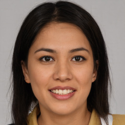 Joyful latino young-adult female with medium  brown hair and brown eyes