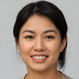 Joyful asian young-adult female with medium  brown hair and brown eyes