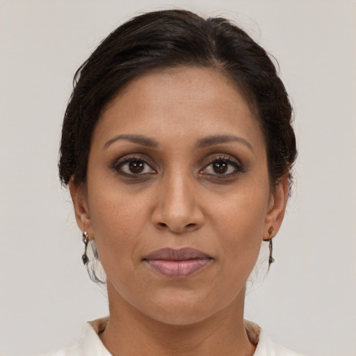 Joyful white adult female with medium  brown hair and brown eyes