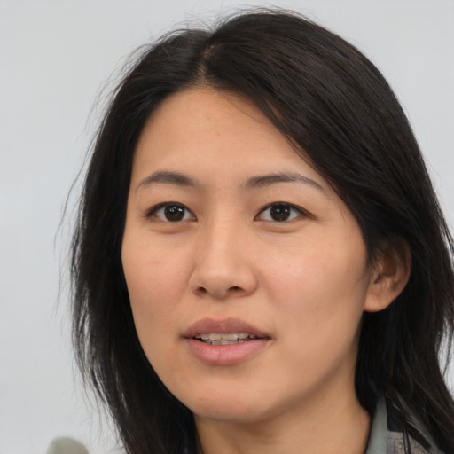 Joyful asian young-adult female with medium  brown hair and brown eyes
