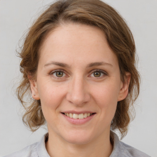 Joyful white adult female with medium  brown hair and grey eyes