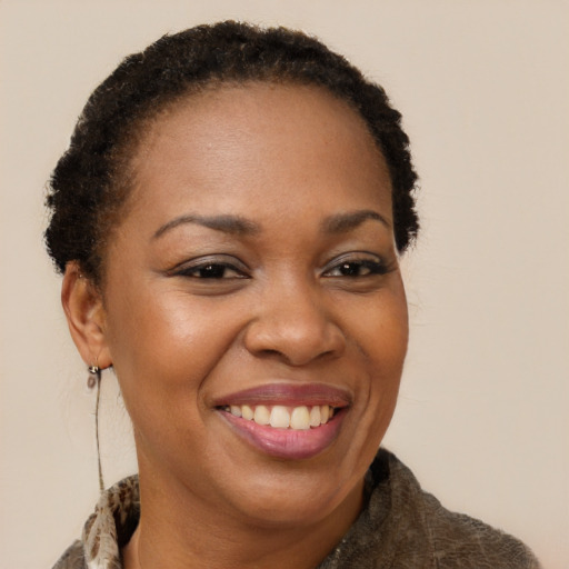 Joyful black adult female with short  brown hair and brown eyes