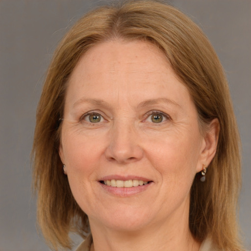 Joyful white adult female with medium  brown hair and grey eyes