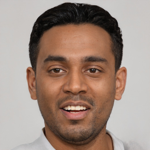 Joyful black young-adult male with short  black hair and brown eyes