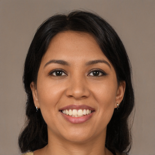 Joyful latino young-adult female with long  black hair and brown eyes
