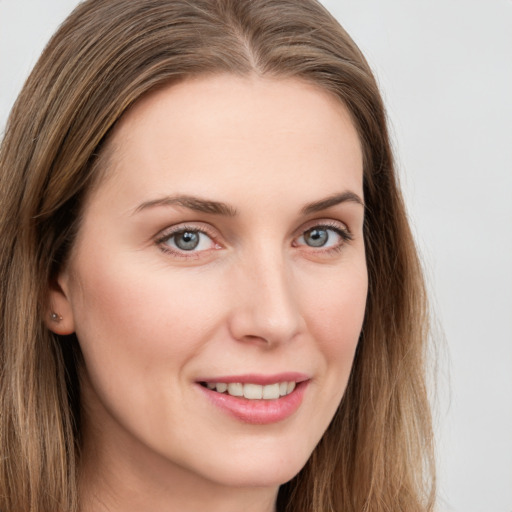 Joyful white young-adult female with long  brown hair and grey eyes