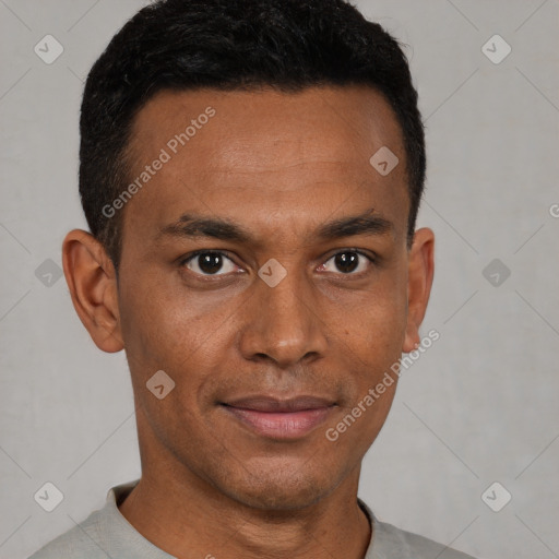 Joyful black young-adult male with short  brown hair and brown eyes