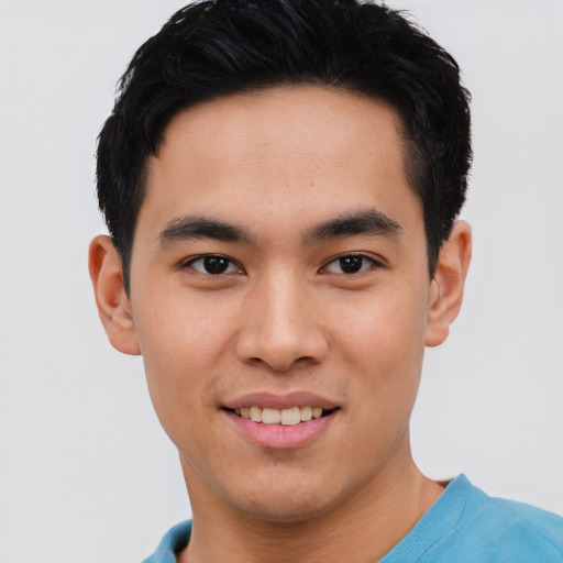 Joyful asian young-adult male with short  black hair and brown eyes