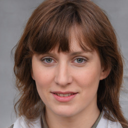 Joyful white young-adult female with medium  brown hair and blue eyes