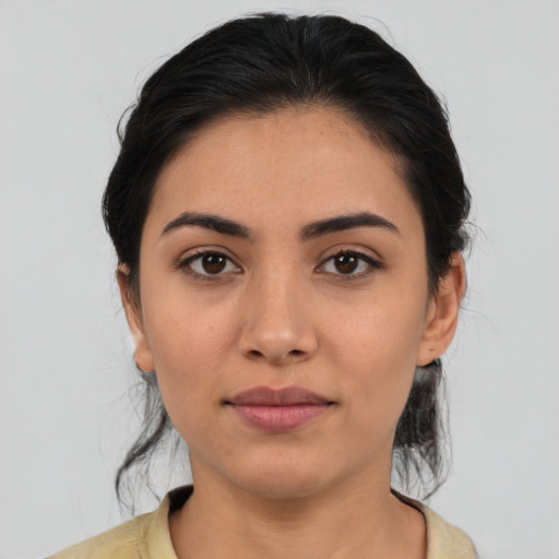 Joyful latino young-adult female with medium  brown hair and brown eyes