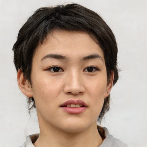 Joyful asian young-adult female with medium  brown hair and brown eyes