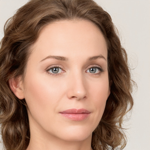 Joyful white young-adult female with long  brown hair and green eyes