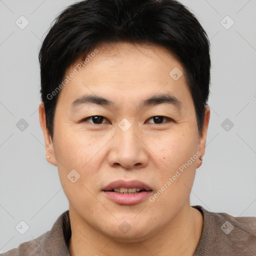 Joyful asian young-adult male with short  brown hair and brown eyes