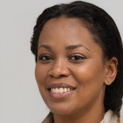 Joyful black young-adult female with medium  brown hair and brown eyes