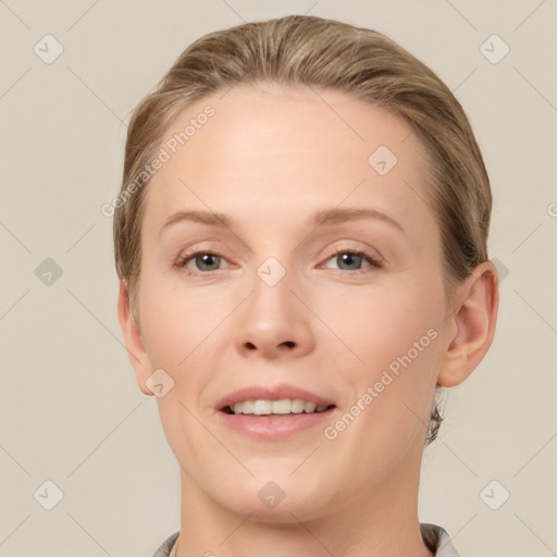 Joyful white young-adult female with short  brown hair and grey eyes