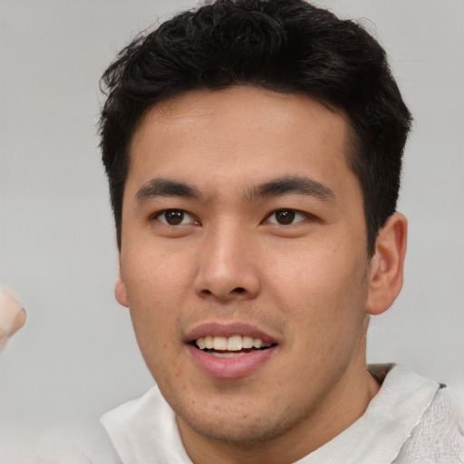 Joyful asian young-adult male with short  brown hair and brown eyes