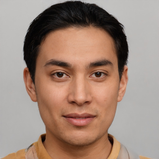 Joyful latino young-adult male with short  black hair and brown eyes