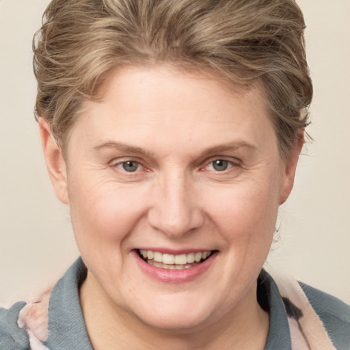 Joyful white adult female with short  brown hair and grey eyes