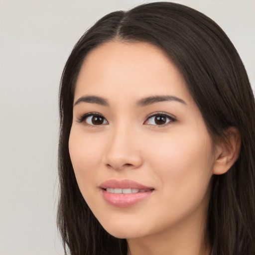 Joyful white young-adult female with long  black hair and brown eyes