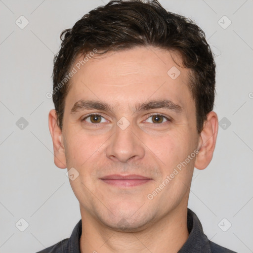 Joyful white adult male with short  brown hair and brown eyes