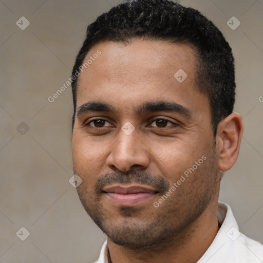 Joyful black young-adult male with short  black hair and brown eyes