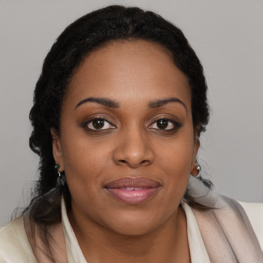 Joyful black young-adult female with medium  brown hair and brown eyes