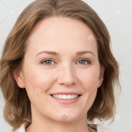 Joyful white young-adult female with medium  brown hair and blue eyes