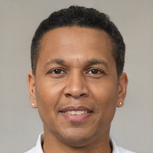 Joyful latino adult male with short  brown hair and brown eyes